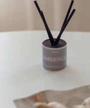 Svenska veganska doftpinnar Ambience på vit yta i varmt, naturligt solsken