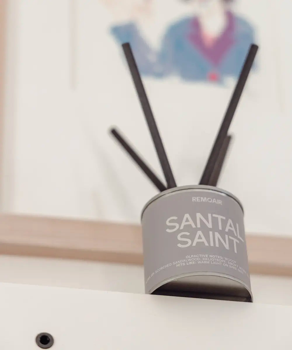 Santal Saint doftpinnar med sober gråbeige etikett i en harmonisk, skandinavisk miljö.