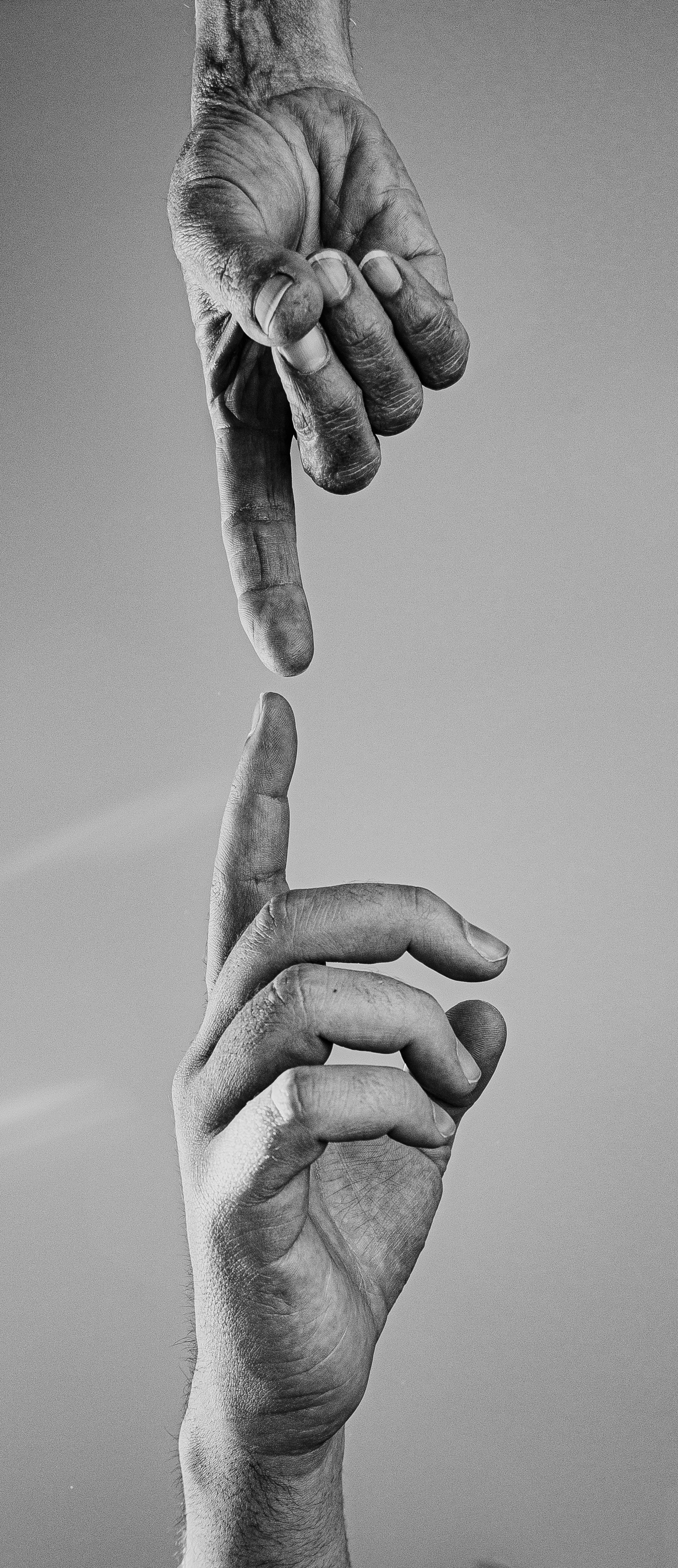 two-reaching-hands-in-black-and-white.jpg